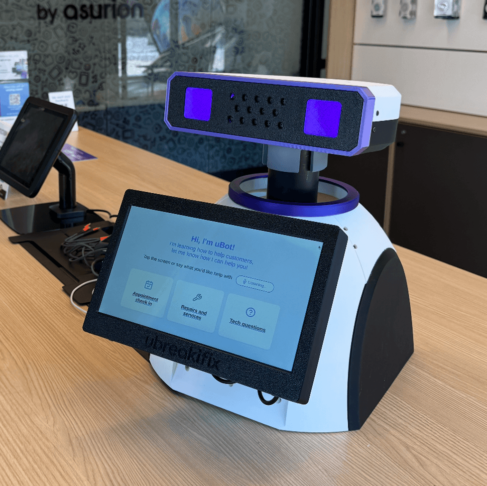uBot, the AI greeter robot, on the counter of a uBreakiFix store